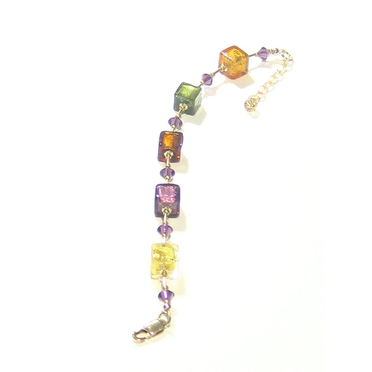 a multicolored beaded cube bracelet on a white background