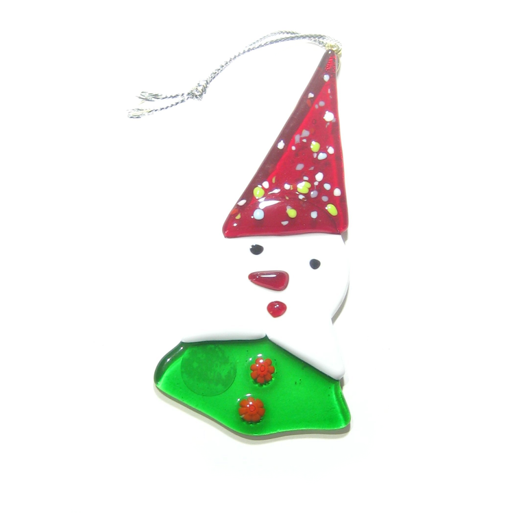 a glass snowman ornament with a red hat on top of it