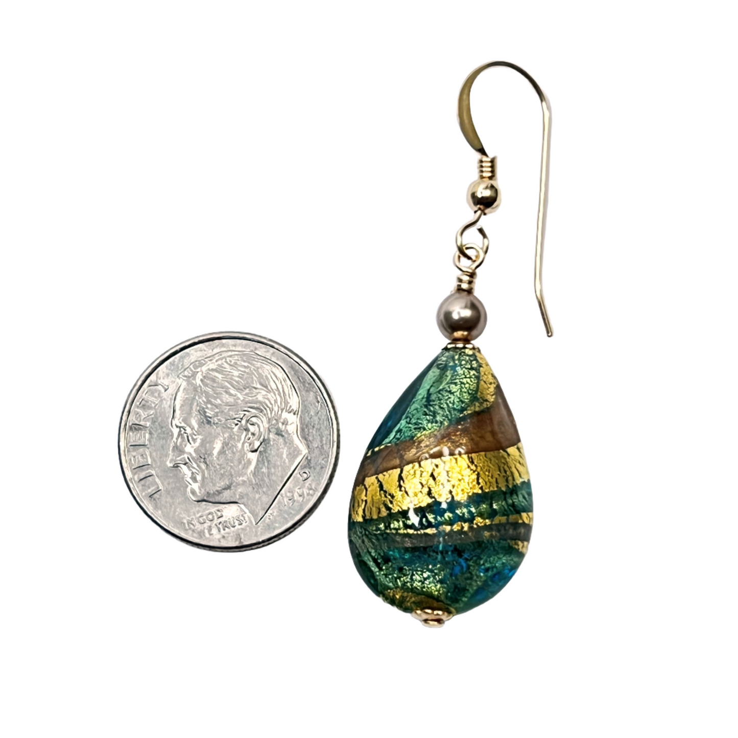 a coin is next to a pair of earrings