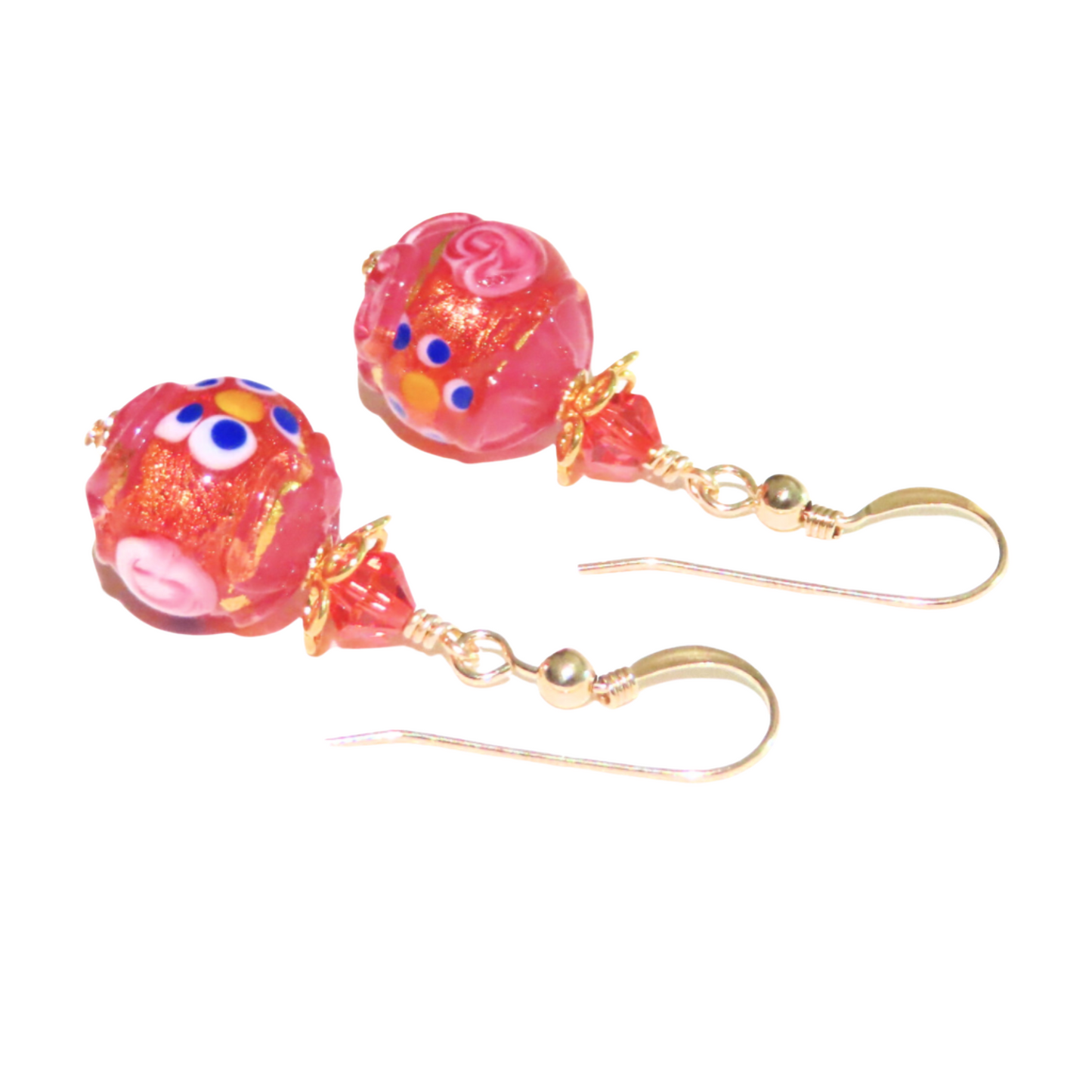 a pair of earrings with pink beads and gold hooks