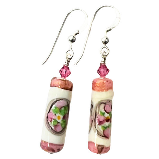 a pair of earrings with pink and green beads