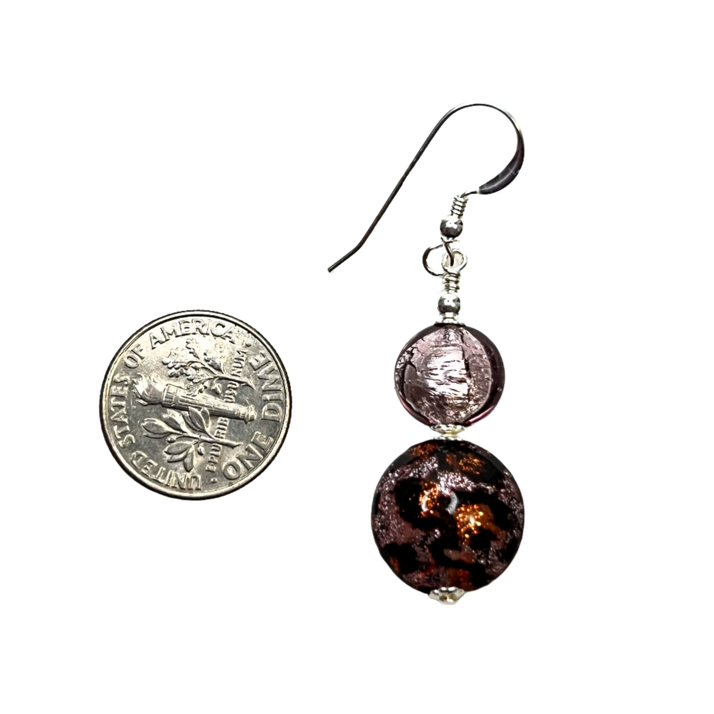 a pair of earrings sitting next to a 
