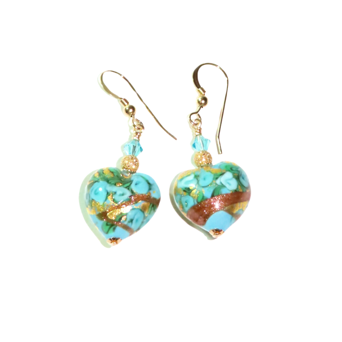 a pair of earrings with a heart shaped design