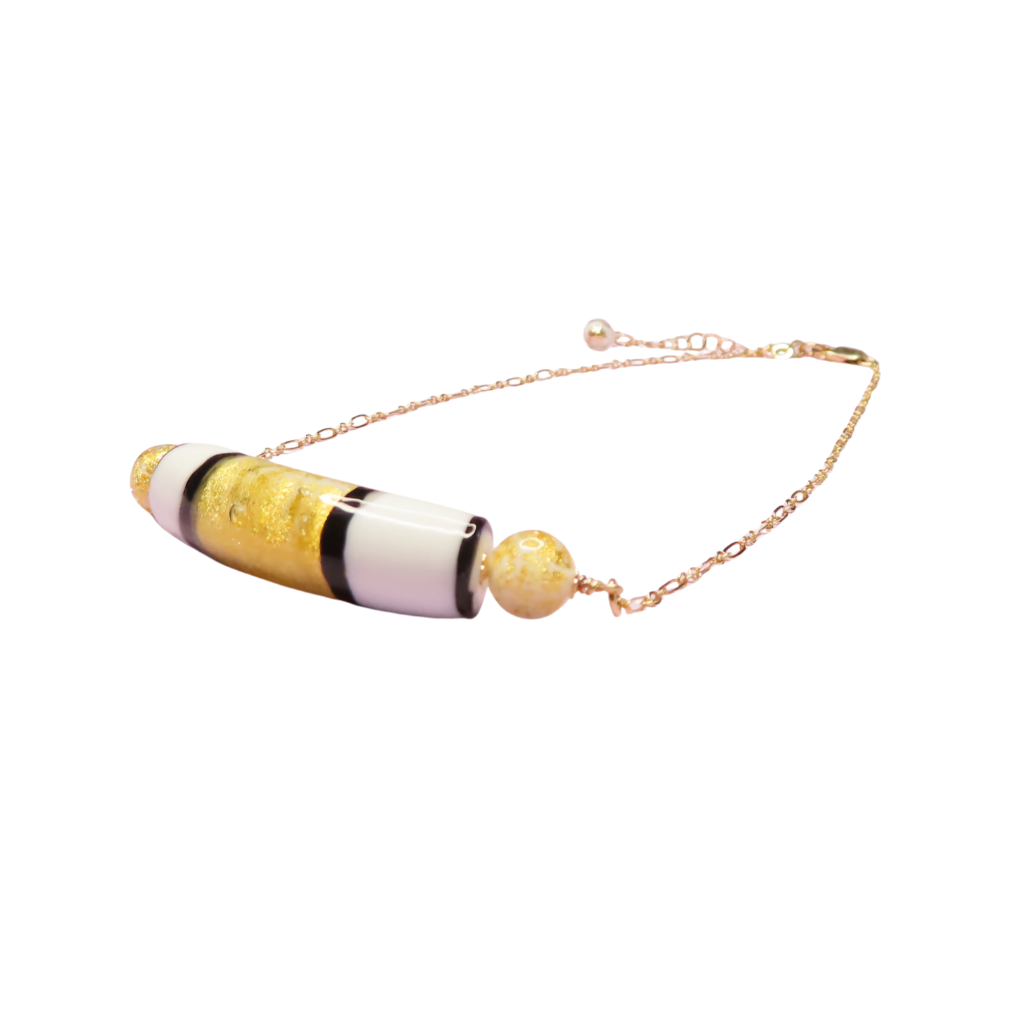 a necklace with a yellow gold and black bead