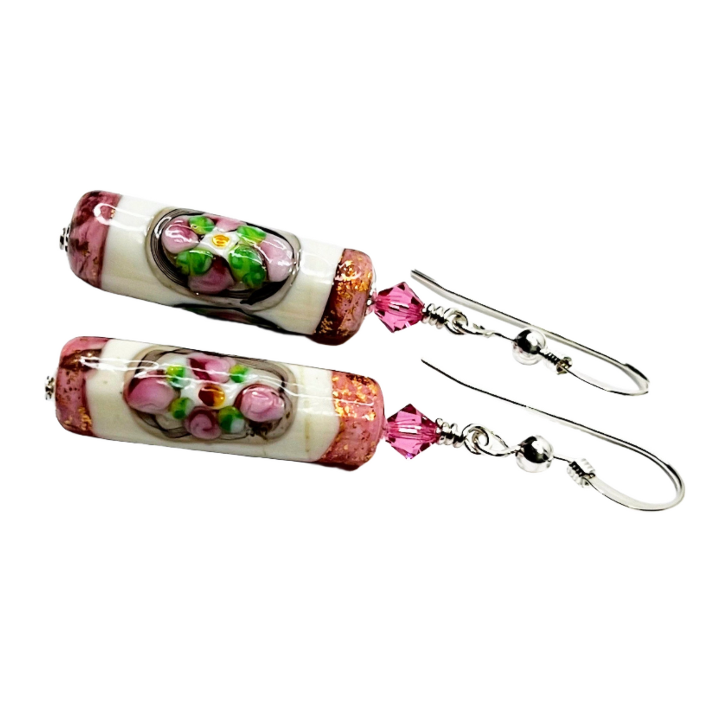 a pair of pink and white earrings with flowers on them