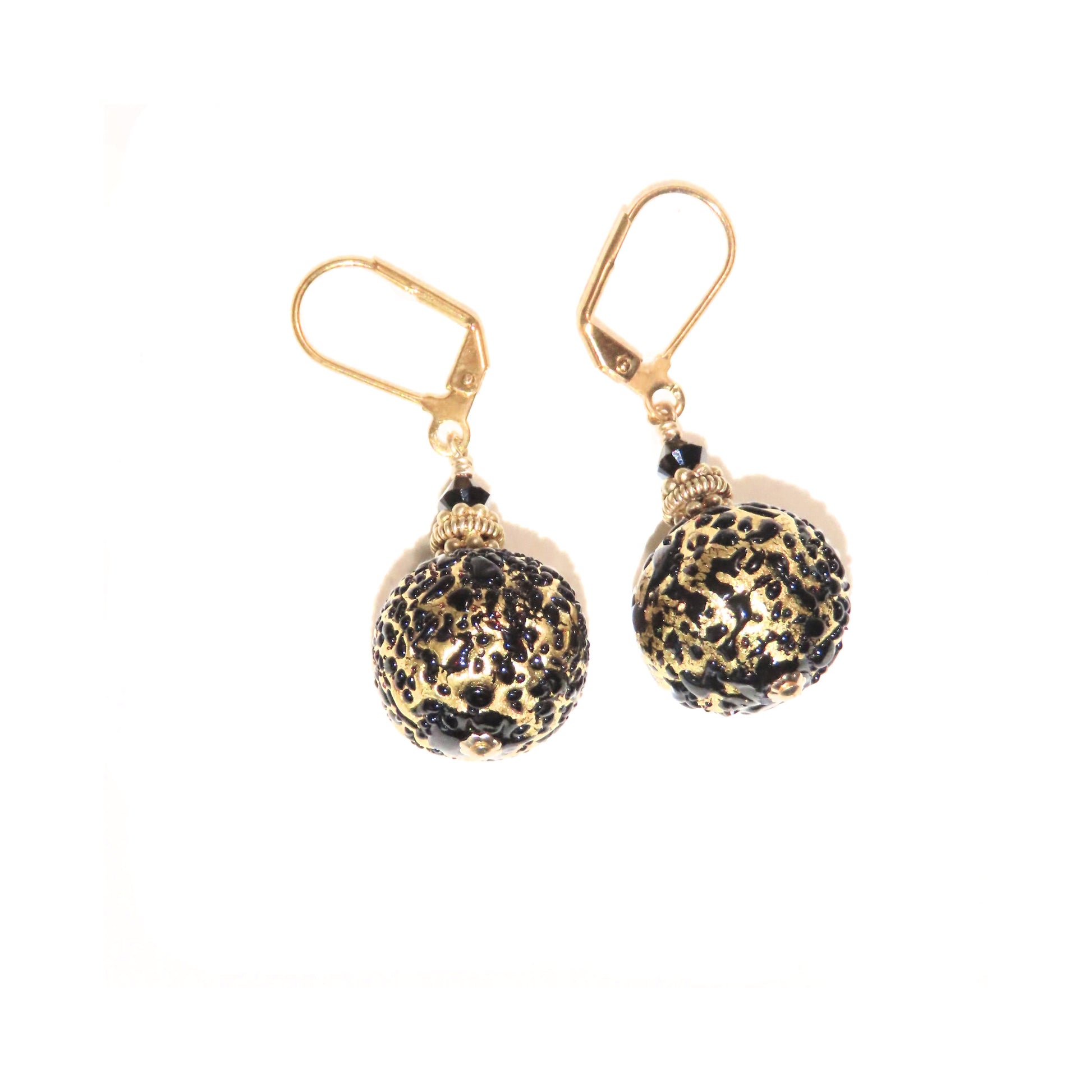 a pair of earrings with a ball on it