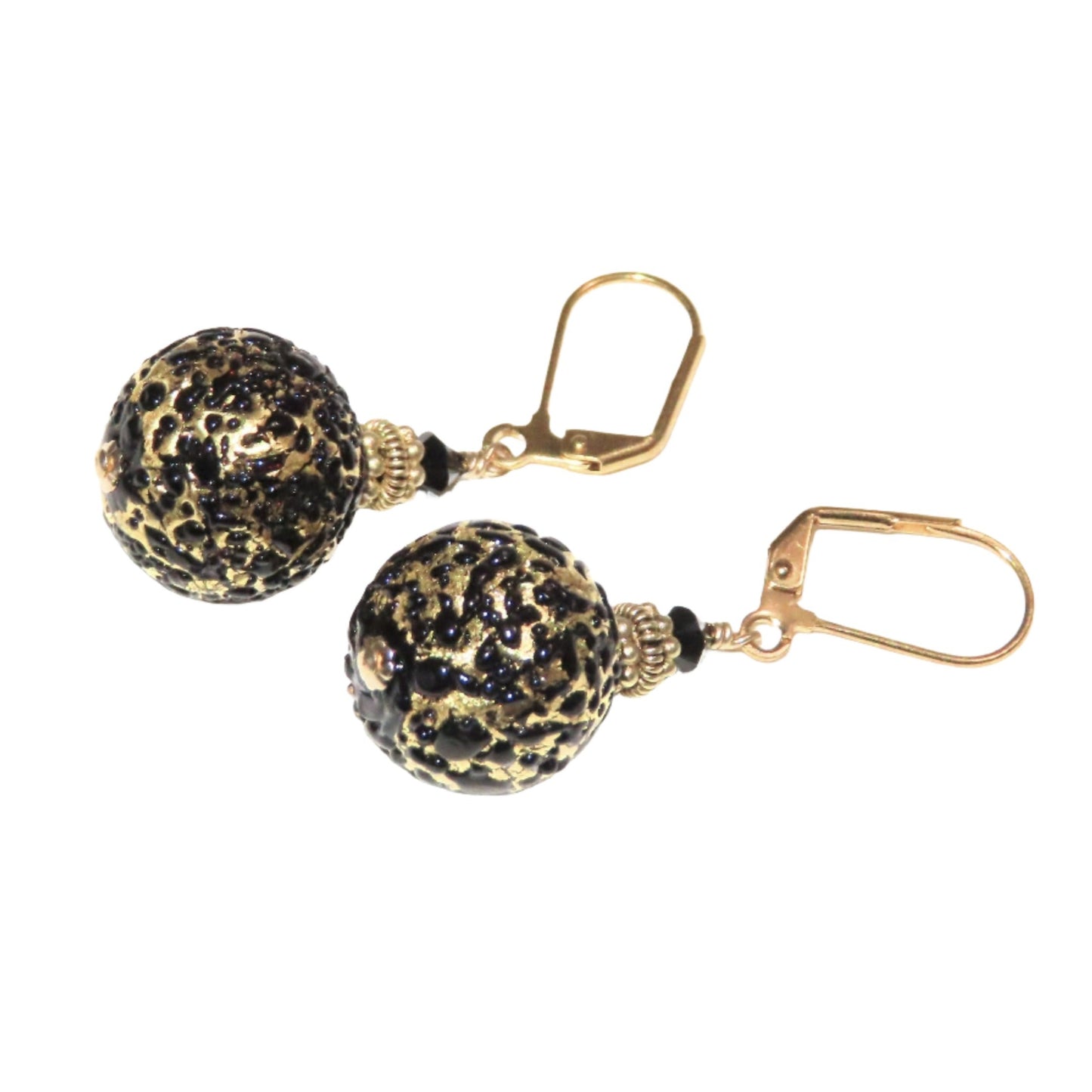 a pair of black and gold beaded earrings