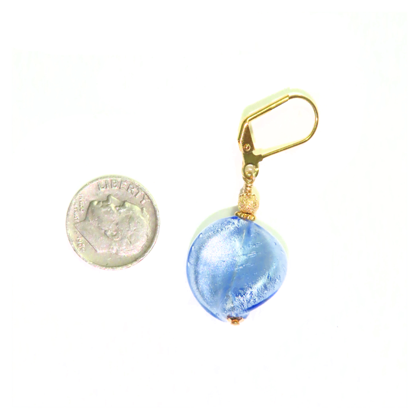 a coin is next to a blue glass bead