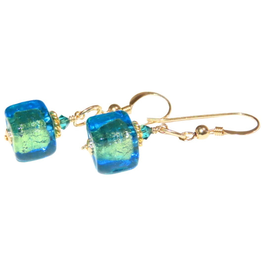 a pair of blue and green earrings on a white background
