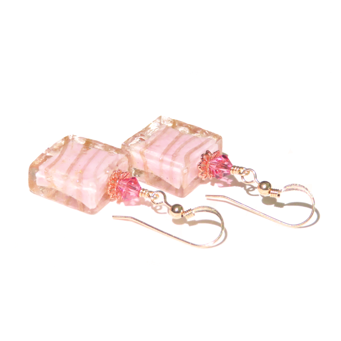 a pair of pink earrings with pink beads