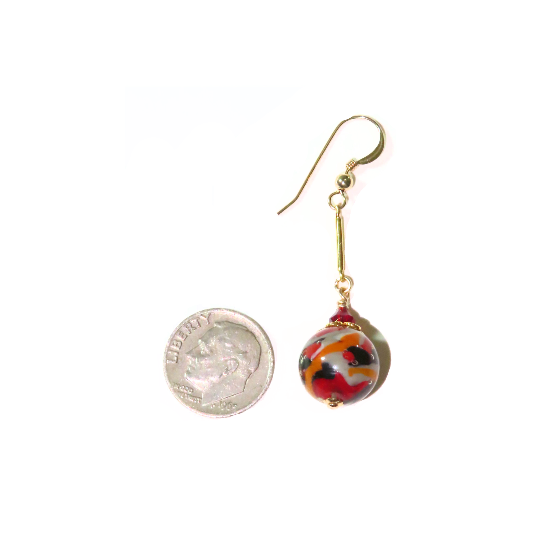 a pair of earrings with a coin hanging from it