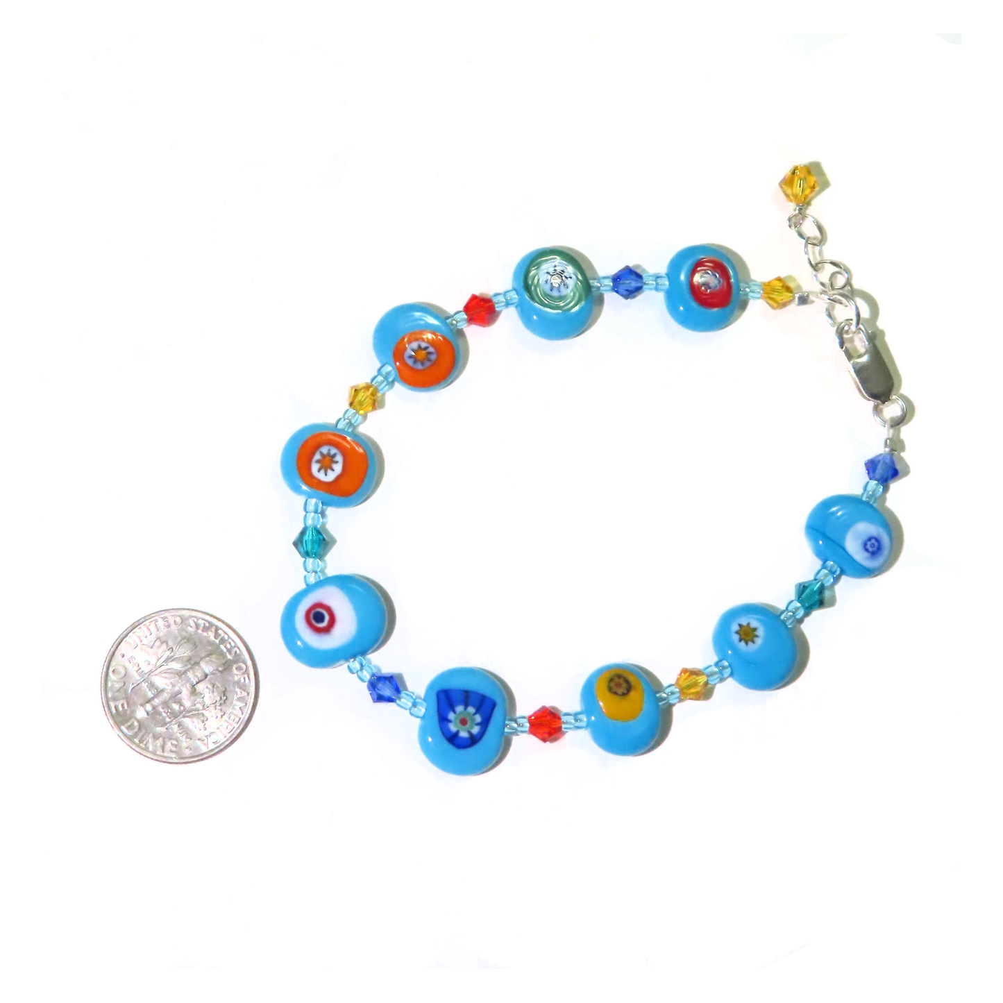 a bracelet with a coin on a white background