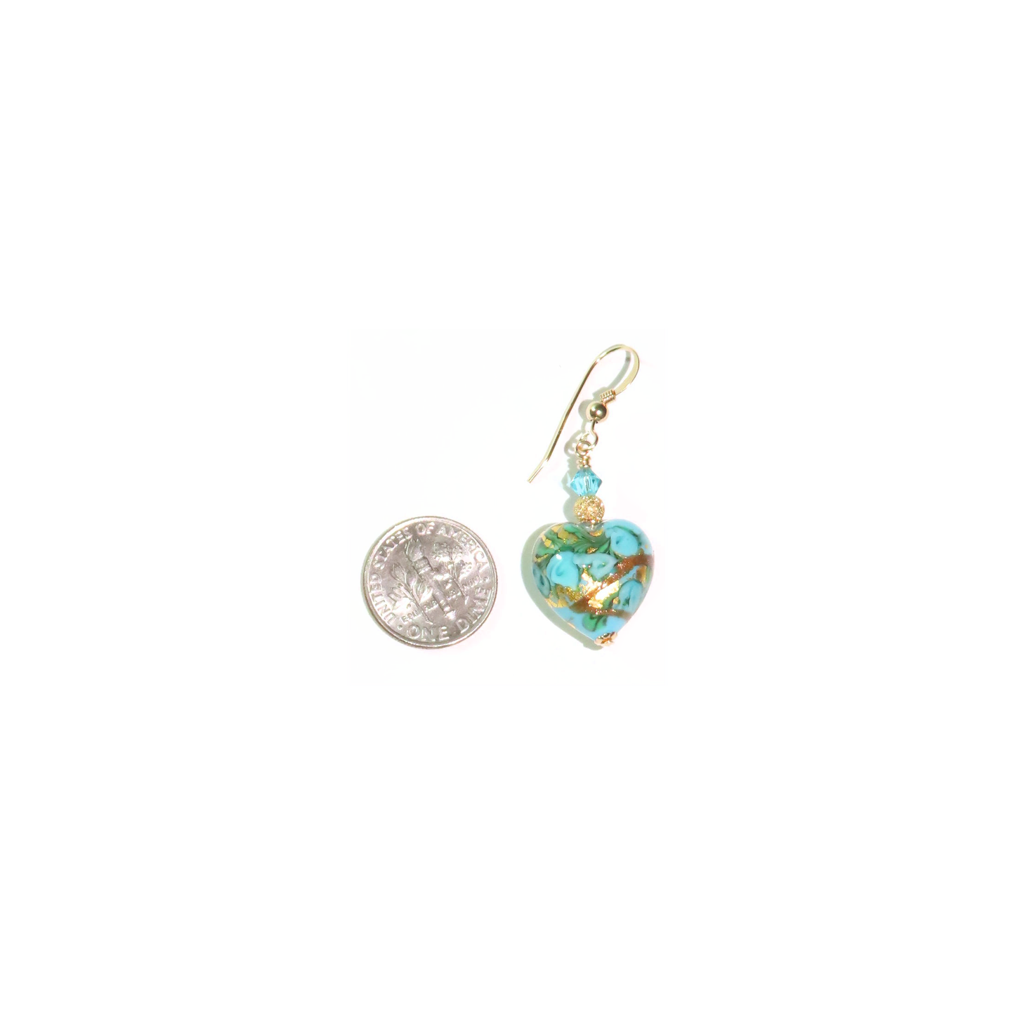 a pair of earrings with a coin on a white background